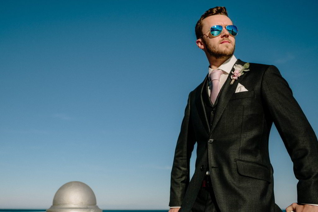 Bräutigam mit Sonnenbrille am Strand